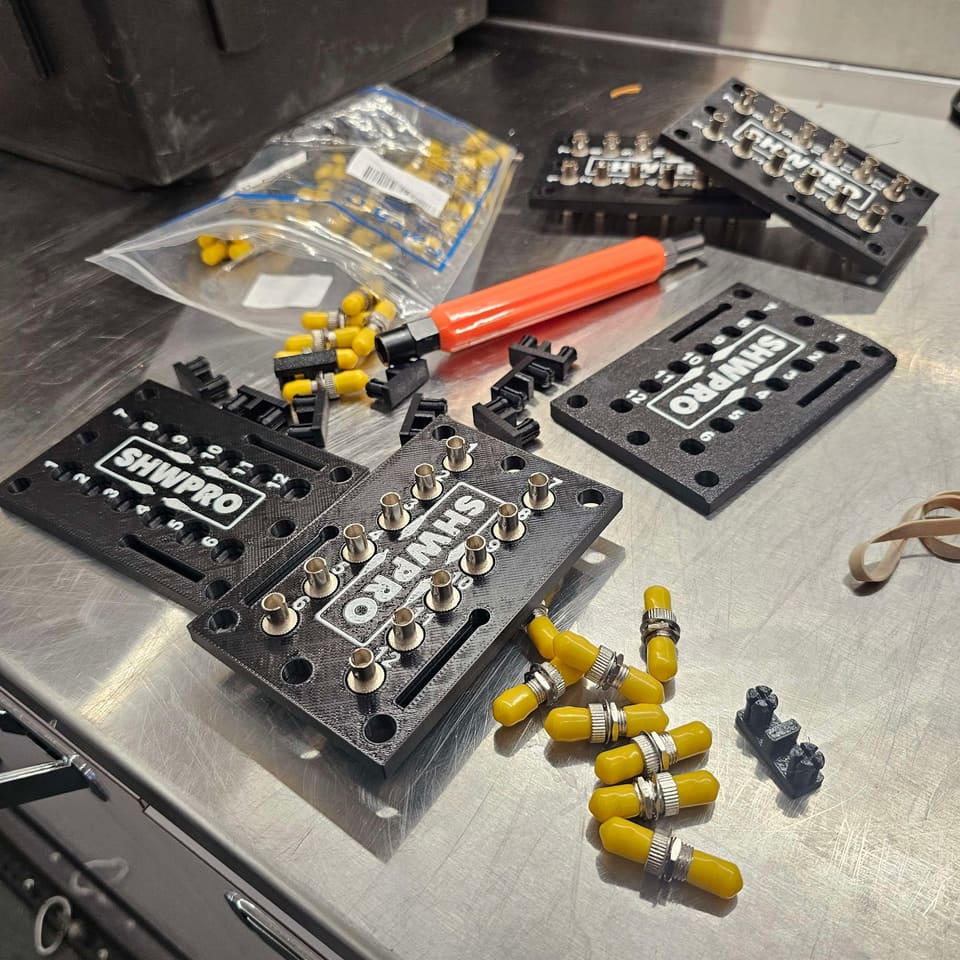 Several ST Patch Panels with loose caps and barrels on a workbench