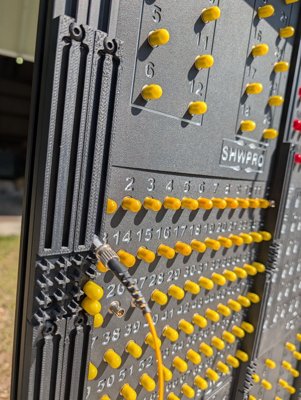 Close-up of a patched fiber jumper in a Control Station side arm