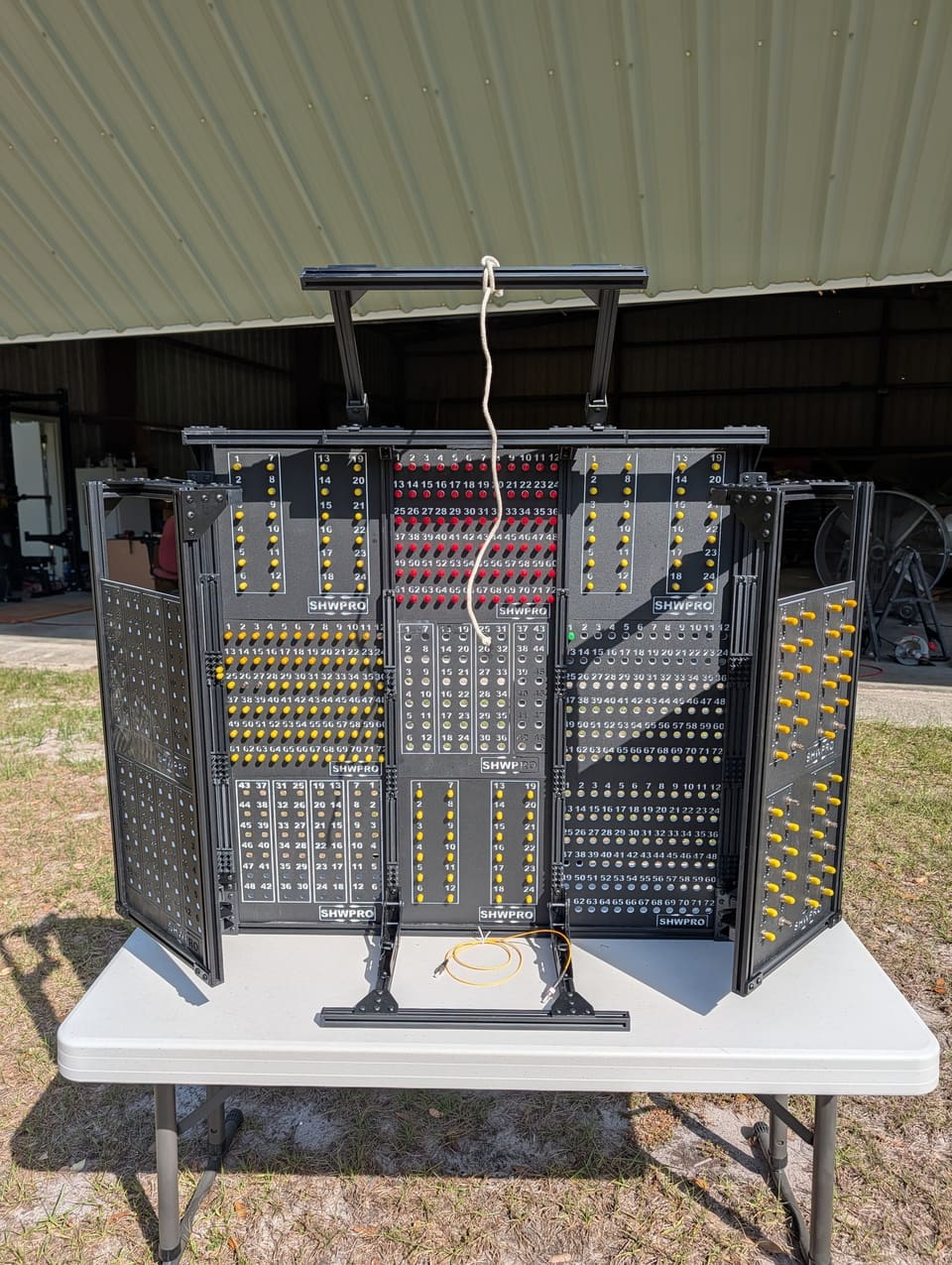 Control Station fully deployed with its center grid and two side arms in front of a building