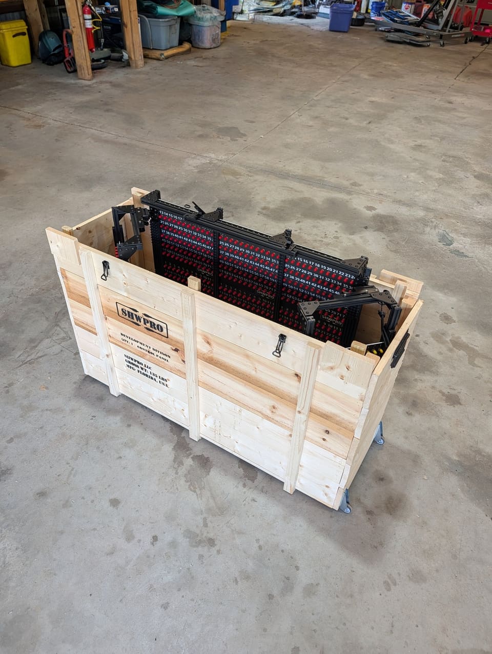 The open wooden crate with the folded Control Station inside