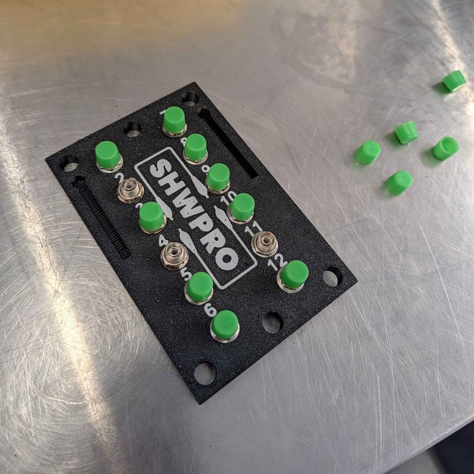 FC Patch Panel with green caps and loose caps beside it