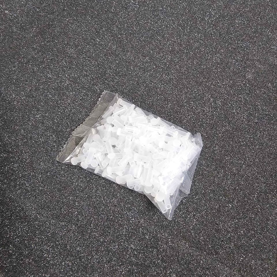 A second angle of the sealed pack of dust caps