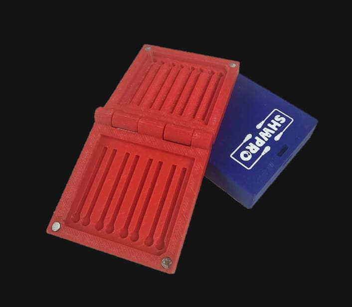 Red LC Cap Case open next to a closed blue case