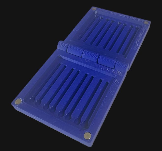 Blue LC Cap Case open showing its cap slots and hinges