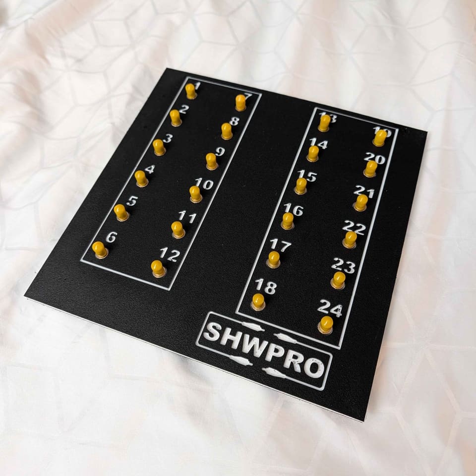 24 ST Frame Panel in black HDPE with yellow ST caps, lying on a white bed