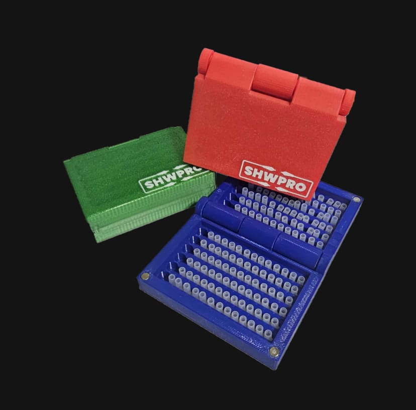 Three ST/FC Cap Cases in red, green, and blue, with the blue case open and loaded with caps
