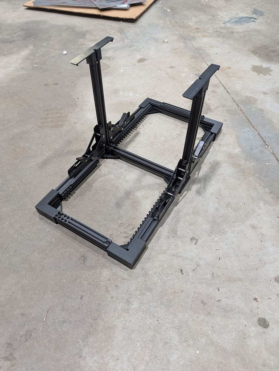 The Frame open on a concrete floor with its two uprights and aluminum base